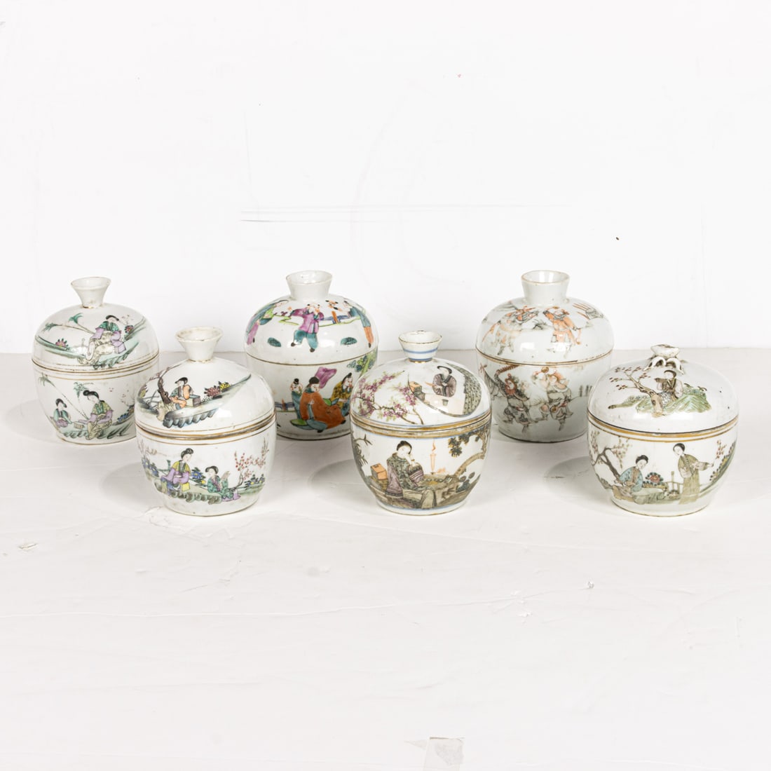 (lot of 6) Chinese famille rose covered jars: (lot of 6) Chinese famille rose covered jars. Depicting figures in the garden setting, Republic period, from 4" to 4.875" high.