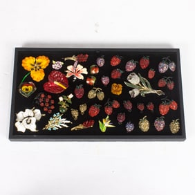Thirty costume jewelry brooches of fruits and florals with five pairs of earrings