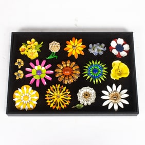 Thirteen 1960's - 70's flower brooches with a pair of earrings