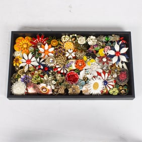 Sixty-three costume jewelry brooches of flowers, comprising Sarah Coventry, Monet and Schreiner,
