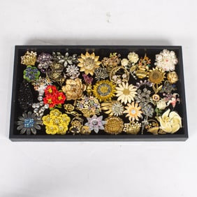 Forty-four costume jewelry brooches of various flowers