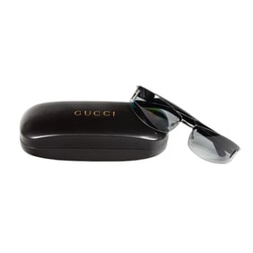 A pair of Gucci sunglasses in case