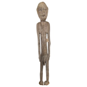 A tall standing carved wood male figure, Papua New Guinea