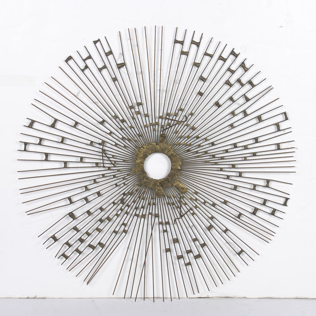 A Brutalist wire sunburst wall sculpture in the manner of Curtis Jere: A Brutalist wire sunburst wall sculpture in the manner of Curtis Jere, 20"dia