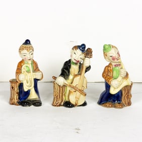 A set of three Mid-Century figural spill vases of musicians