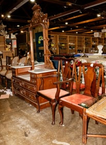 A group of chairs and a Victorian dresser