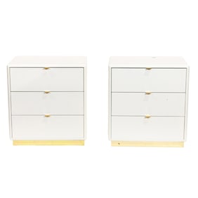 A pair of contemporary white three-drawer nightstands