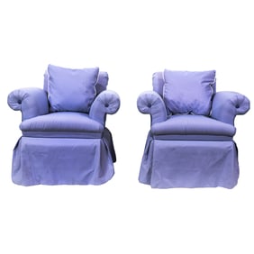 A pair of light purple swivel lounge chairs