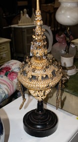 A Thai headdress raised on turned wood stand