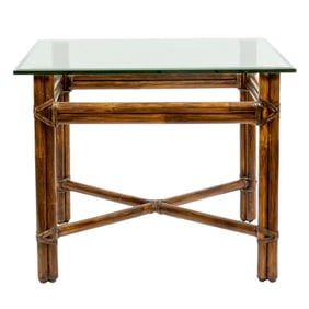 A McGuire rattan and glass side table