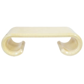 A Karl Springer style parchment covered scroll cocktail table