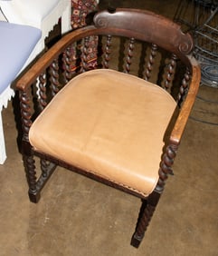 An oak barrel back chair with barley-twist frame and seat cushion