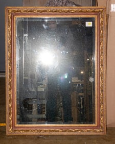 A contemporary polychrome and gilt mirror with beveled plate in the Classical taste