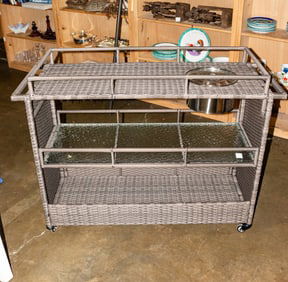 A contemporary three tier woven outdoor bar cart fitted with icebucket