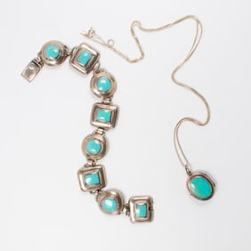 A turquoise and sterling silver bracelet and pendant necklace set