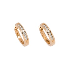 A pair of diamond and 14k gold huggie earrings