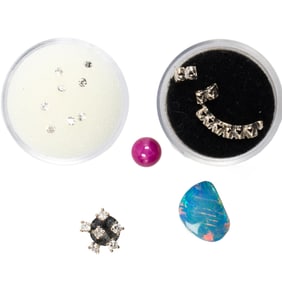 A group of unmounted gemstones and jewelry findings