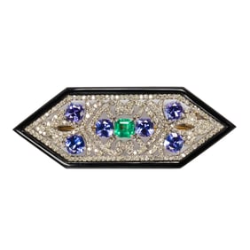 An emerald, tanzanite, diamond, onyx, silver, and 14k gold brooch