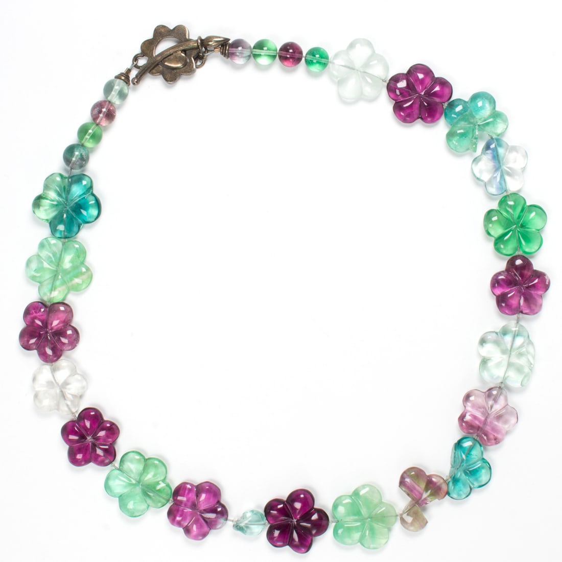 A beaded tourmaline necklace: A beaded tourmaline necklaceDesigned with flower-shaped and round tourmaline beads, set with silver clasp; length: 20 in; 80.75 grams*Condition note: five flower beads broken