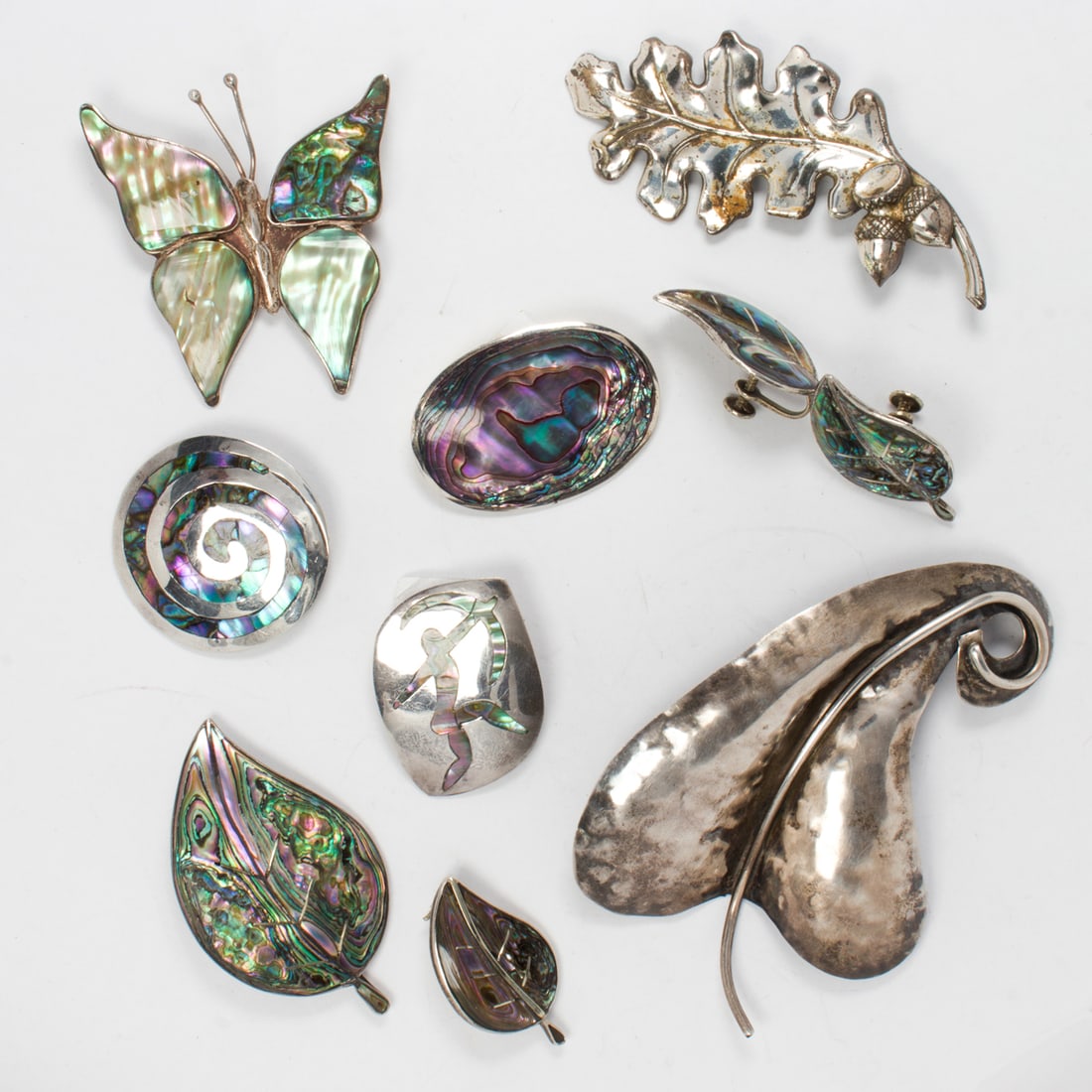 A group of mostly mexican silver jewelry: A group of mostly mexican silver jewelrycomprising 8 brooches and one pair of ear clips; 72.40 grams