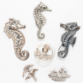 Seven sterling silver brooches