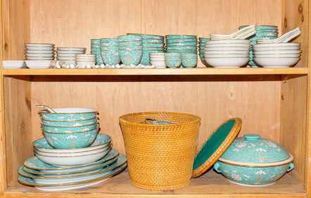 Two shelves of Chinese turquoise ground dinner service