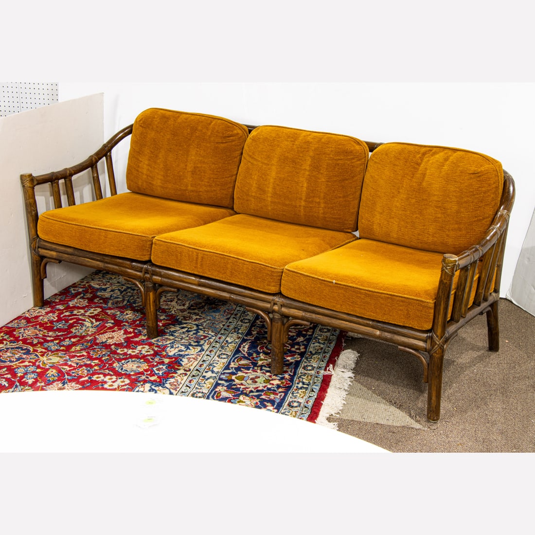 A McGuire rattan sofa upholstered in rust (1 of 3)
