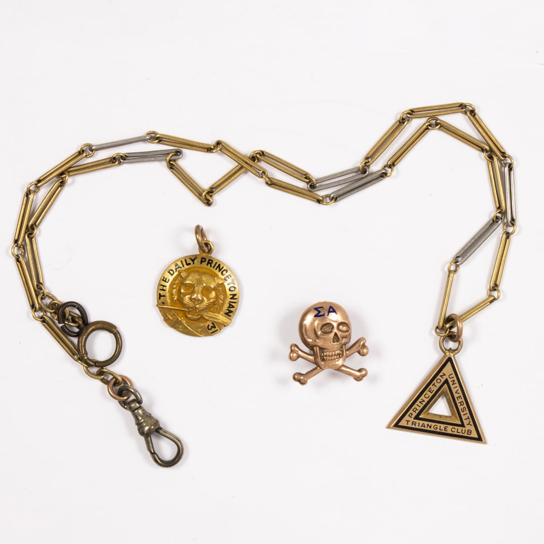 A group of three gold fill Princeton college objects: A group of three gold fill Princeton college objects comprising a Triangle Club, Daily Princetonian club and fraternity pin; 24.10 grams
