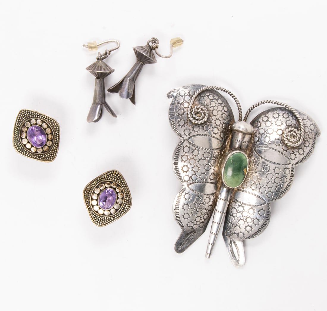 A hardstone and silver brooch and two pairs of earrings: A hardstone and silver brooch and two pairs of earrings The brooch designed as a butterfly, centering a green hardstone cabochon, together with two pairs of silver earrings; brooch length: 2 3/4 in; g