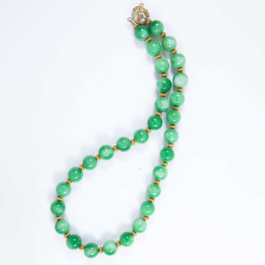A green and gold-tone beaded necklace: A green and gold-tone beaded necklace Designed with round shaped beads measuring 15.72 mm, interspersed by gold-tone beads; length: 25 1/2 in; 204.60 grams
