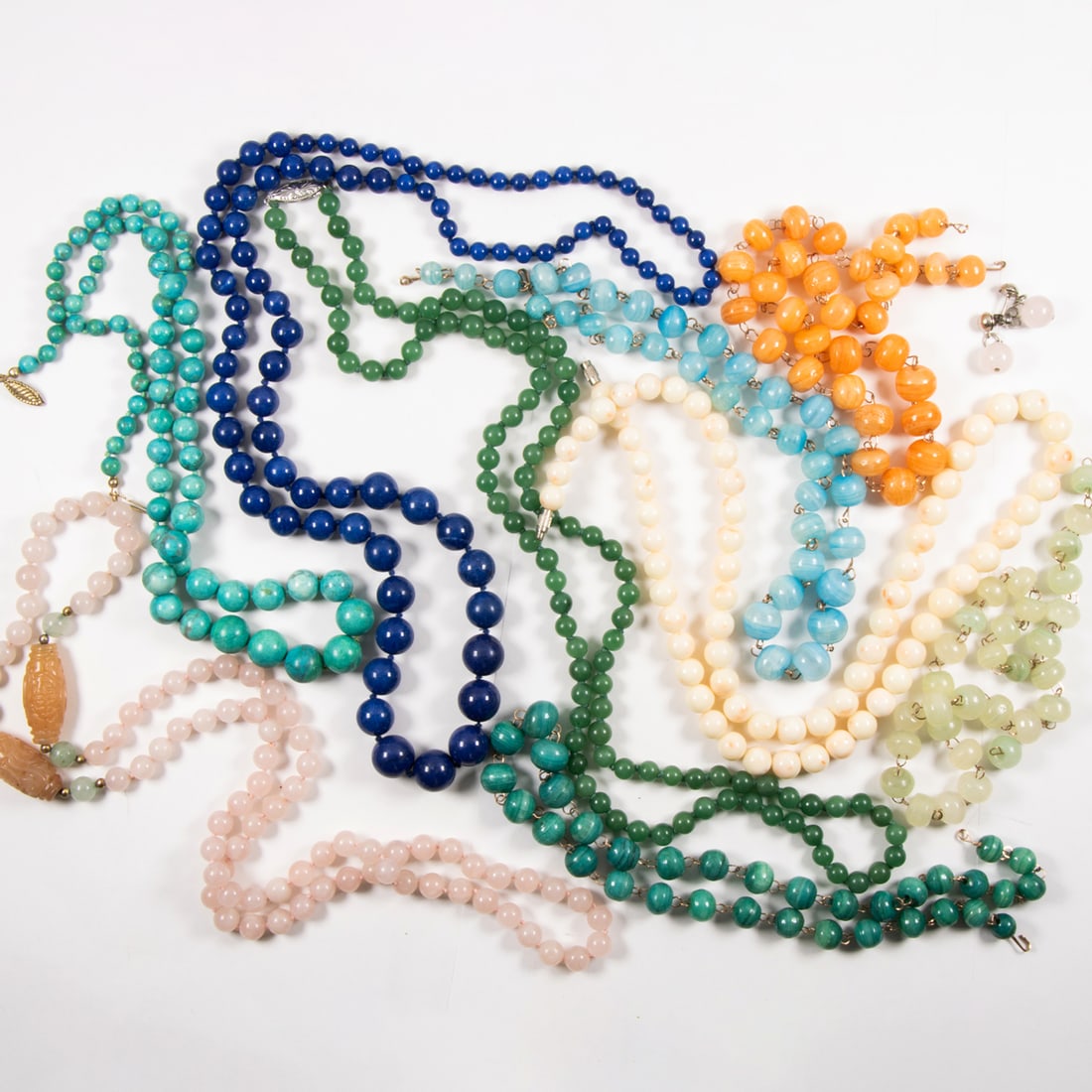 A group of glass and hardstone beaded necklaces: A group of glass and hardstone beaded necklaces Comprising an assortment of beaded necklaces of a variety of materials including rose quartz, coral, and glass; gross weight: 1.25 lbs