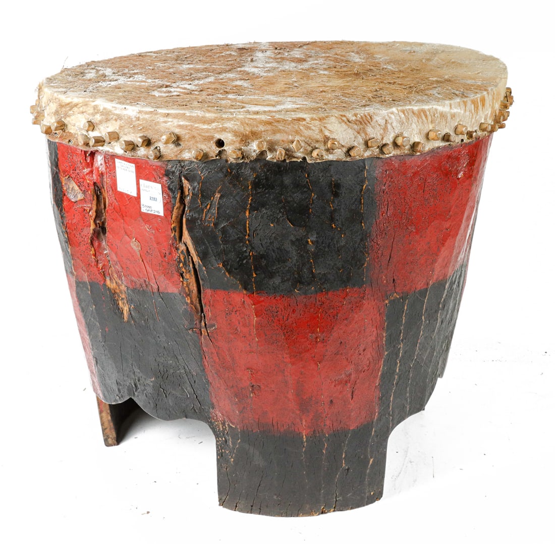 A tribal polychrome and hide drum: A tribal polychrome and hide drum, approximately 24"h x 26"w