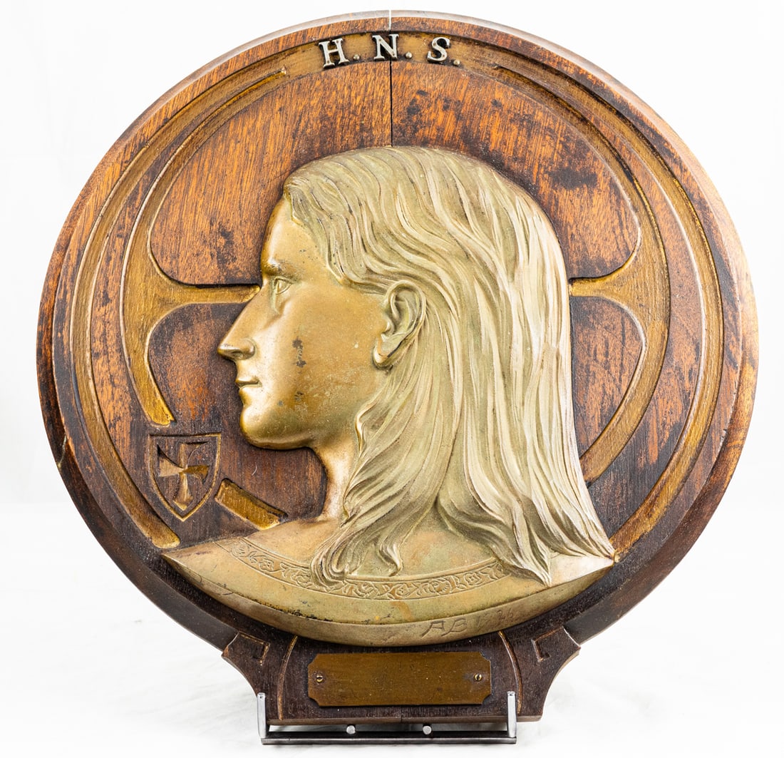 An Art Nouveau brass high relief profile of a youth on wood plaque (1 of 4)