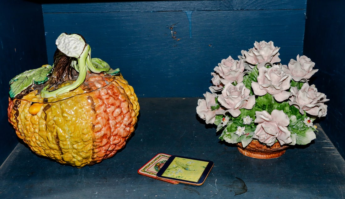 Two Italian ceramic table articles: An Italian pottery pumpkin form tureen with handle and ladle with a Capodimonte floral arrangement, 10.5"h. (2) coasters accompany the lot. [4 total]