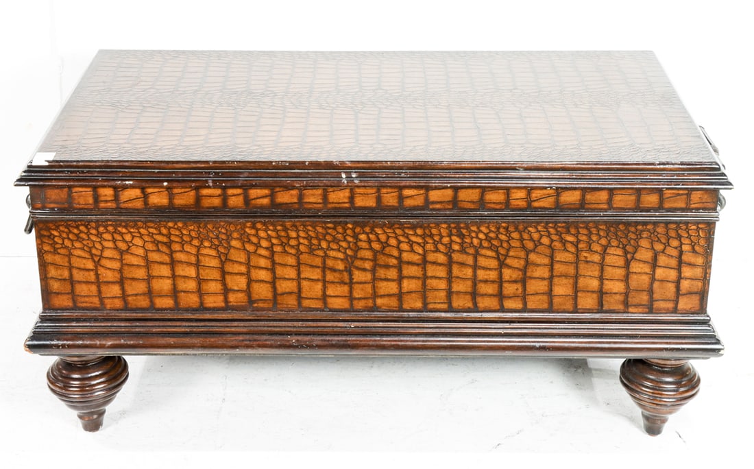 A Victorian style crocodile embossed trunk style coffee table: A Victorian style crocodile embossed trunk style coffee table, with hinged top raised on turned feet, 22"h x 59"l x 28"l