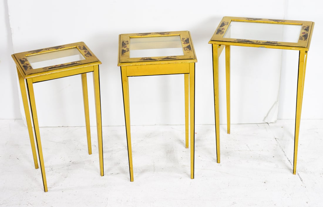 A set of three Chinoiserie decorated nesting tables: A set of three Chinoiserie decorated nesting tables, each with inset glass top, largest 22.5"h x 15"w x 11.5"d. Provenance: The Collection of Adolphus Andrews Jr. and Emily Taylor Andrews