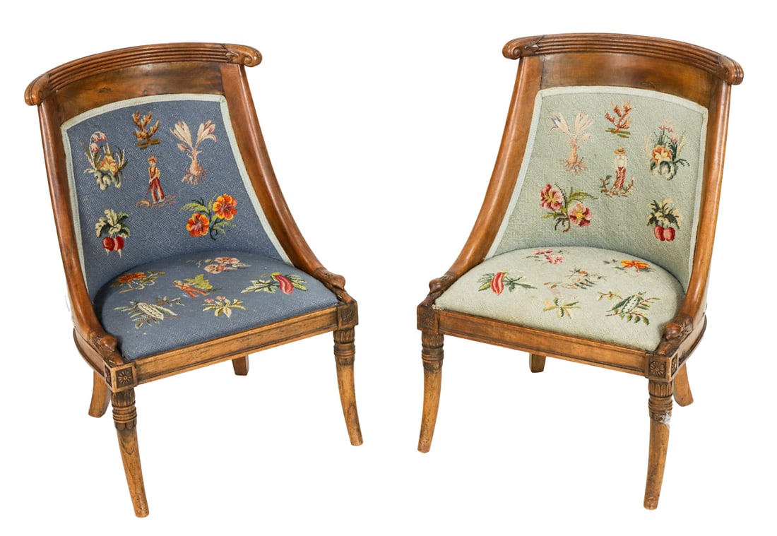 A pair of Empire upholstered gondola chairs: A pair of Empire upholstered gondola chairs, each with needlepoint upholstery, 27"h x 18.5"w; seat 12"h