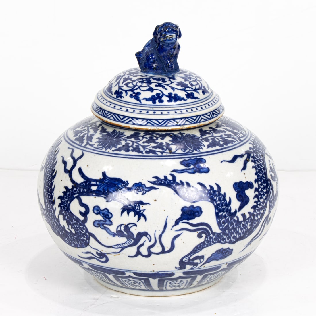 A Chinese blue and white dragon covered jar: A Chinese blue and white dragon covered jar. Depicting dragon motif, 11.5" high.