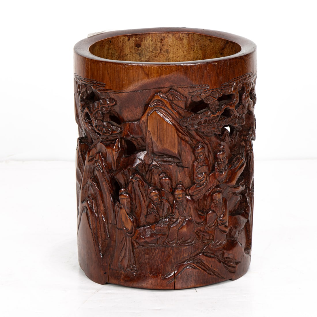 A Chinese bamboo brush pot: A Chinese bamboo brush pot. Depicting figures in landscape setting, 6.75" high.