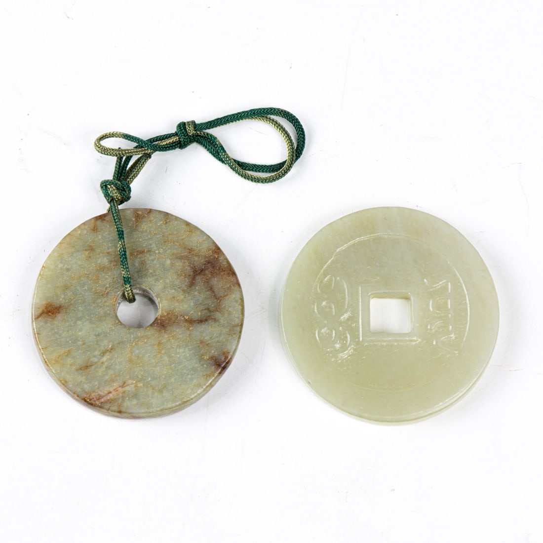 (lot of 2) Chinese jade bi discs: (lot of 2) Chinese jade bi discs. From 2.125" to 2.25" across.