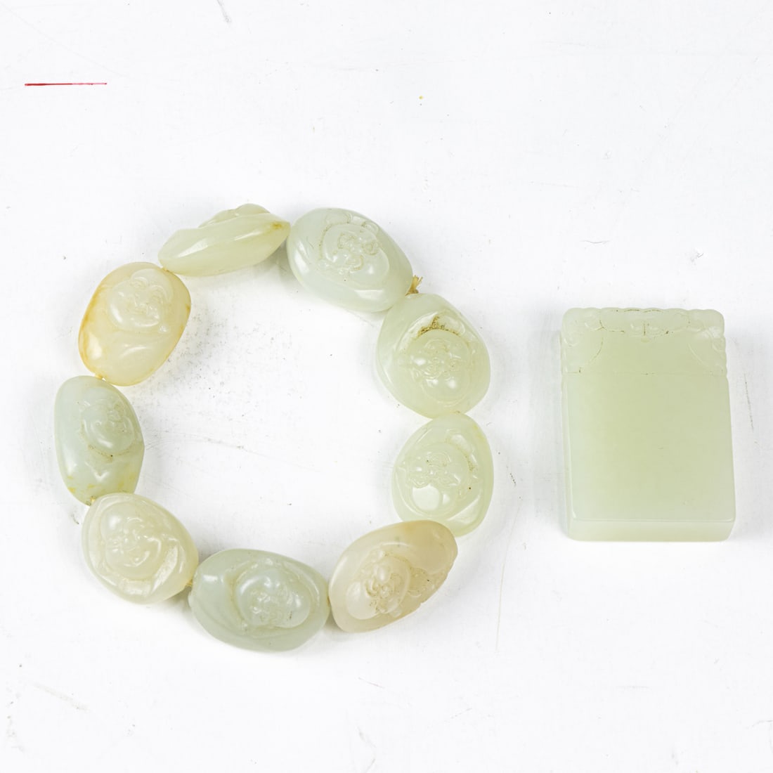 Two Chinese white jade objects: Two Chinese white jade objects. Comprising a rectangular pendant and a beaded bracelet, 1.5" height of pendant.