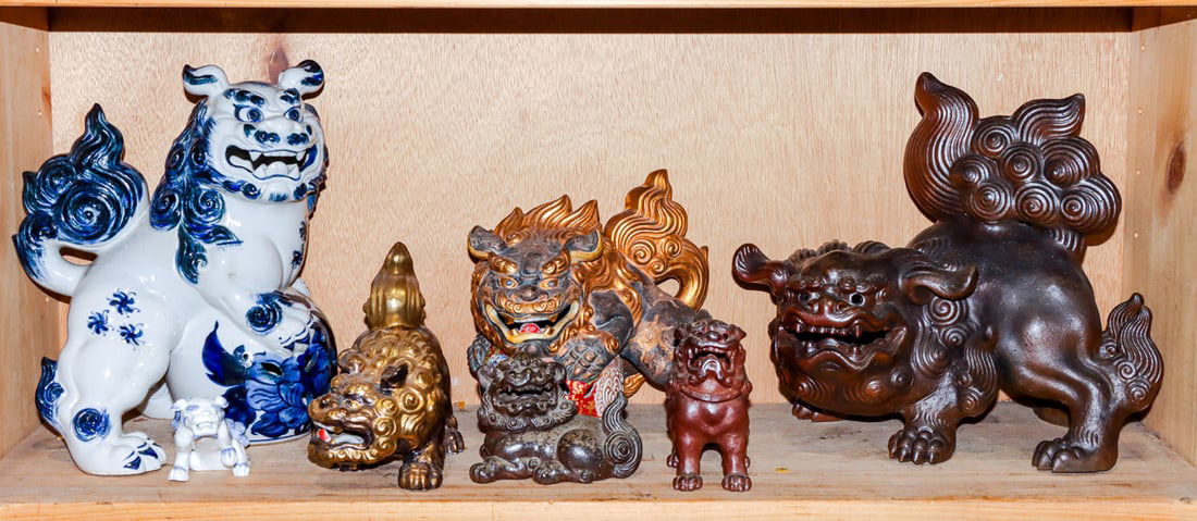 A shelf of Japanese ceramic shishi figures: A shelf of Japanese ceramic shishi figures. 20th century, 12.25" widest.