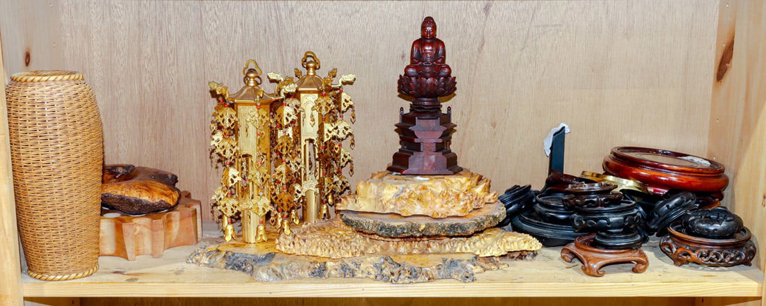 A shelf of Japanese wood stands and various decorative objects: A shelf of Japanese wood stands and various decorative objects. 20th century, 9.625" tallest.