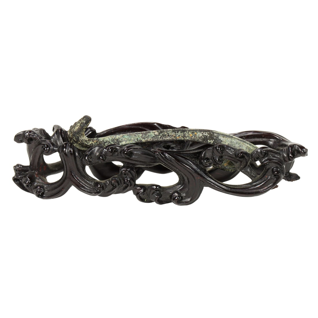 A Chinese bronze belt hook and wood stand: A Chinese bronze belt hook and wood stand. Han dynasty, 2.125" across.