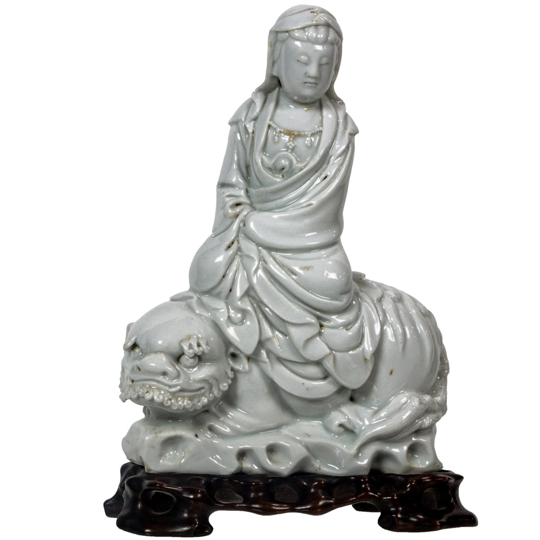 A Chinese Dehua seated figure of Guanyin: A Chinese Dehua seated figure of Guanyin. Depicting Guanyin seated on lion, 19th century, 7.375" high.