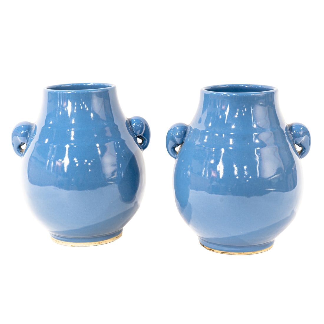 A pair of Chinese sky blue glazed hu form vases: A pair of Chinese sky blue glazed hu form vases. Flanked by a pair of elephant-head handles, Late 19th/early 20th century, 9" high.