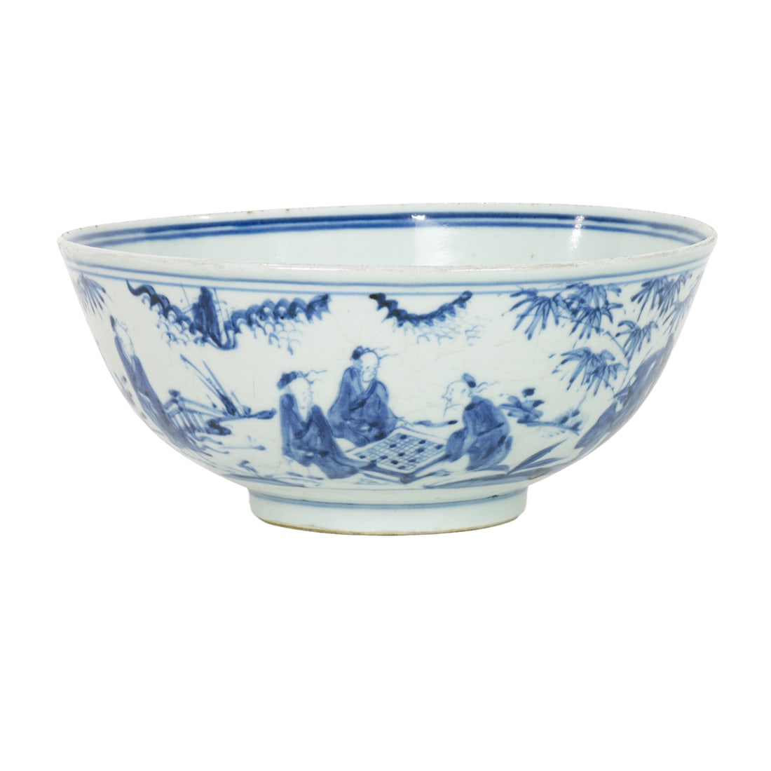 A Chinese blue and white bowl: A Chinese blue and white bowl. Decorated in the Hongzhi style with a continuous scene depicting various scholars in a garden setting, surrounded by bamboo, rockwork, the interior centered with a round