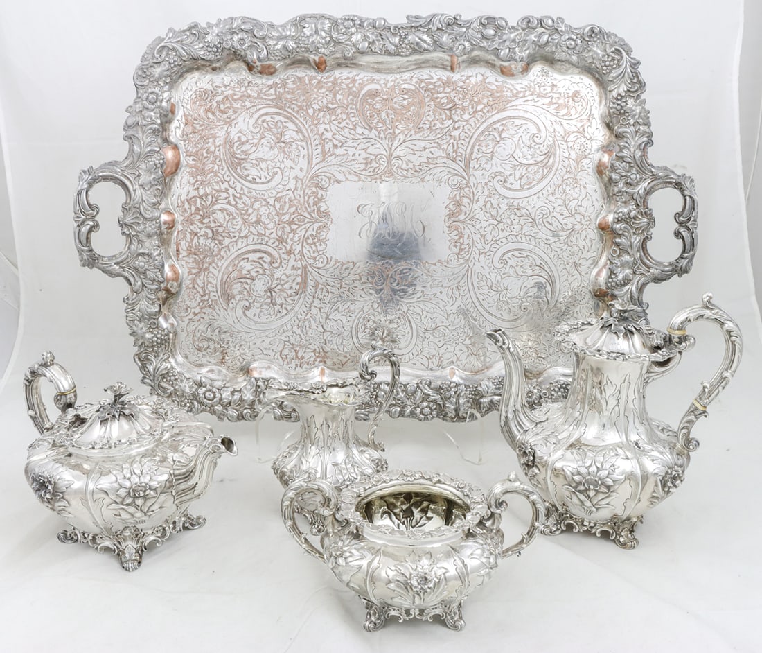 A Four-piece Edward Edwards and John and William Barnard, London Sterling Service: A Four-piece Edward Edwards and John and William Barnard, London Sterling Service, 1836-37. Extensive repousse floral motif in high relief, and flower form finials to covers of the pots. Comprising (1