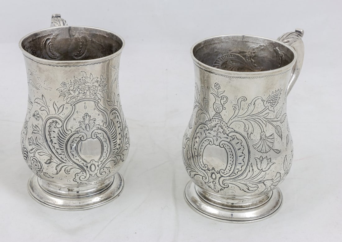 Two Sterling Tankards, likely East Indian: Two Sterling Tankards, likely East Indian. Nicely chased bodies depicting English male and female figures engaging with Indonesian figures in tropical backdrop. 5.75"h. 31.44 Troy oz. [2 Total]