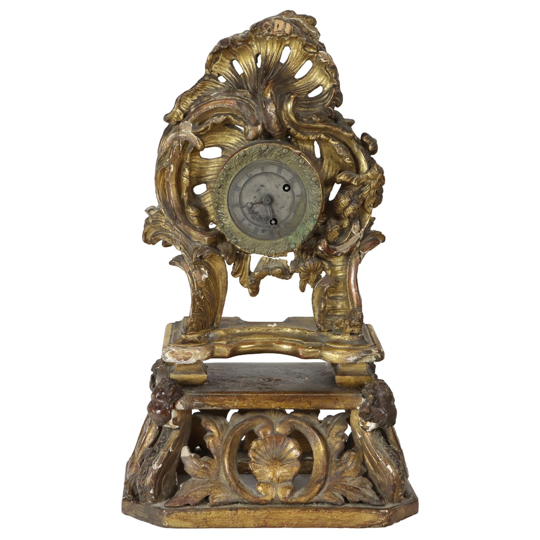 A Rococo giltwood mantel clock on stand: A Rococo giltwood mantel clock on stand, 18th century and later, the silvered dial with Roman numerals within a cartouche shaped case, raised on separate plinth incorporating shells and amorini, overa